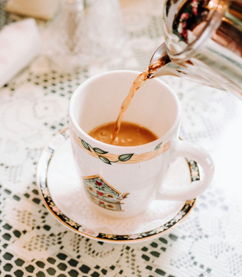 Tea being poured into a cup.